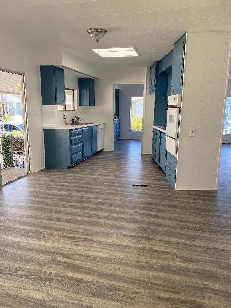 1220 Tasman Drive, Unit 159 Sunnyvale, CA 94089 - Photo 1 of 46 a view of a kitchen with kitchen island wooden floor and window