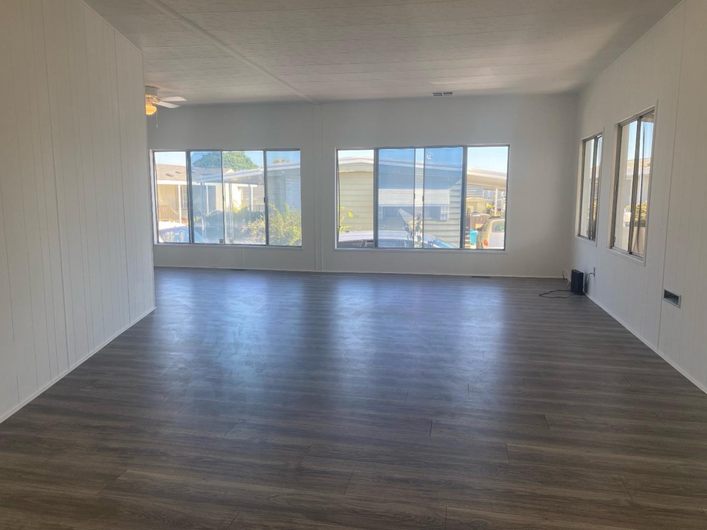 1220 Tasman Drive, Unit 159 Sunnyvale, CA 94089 - Photo 4 of 46 an empty room with wooden floor and windows