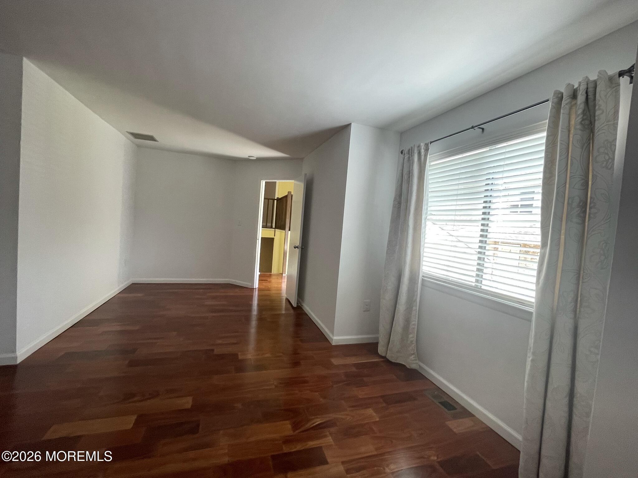 19 Clavendon Court Middletown, NJ 07748 - Photo 10 of 21 a view of an empty room with window and wooden floor