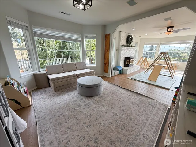 a spacious bedroom with a bed and a flat screen tv