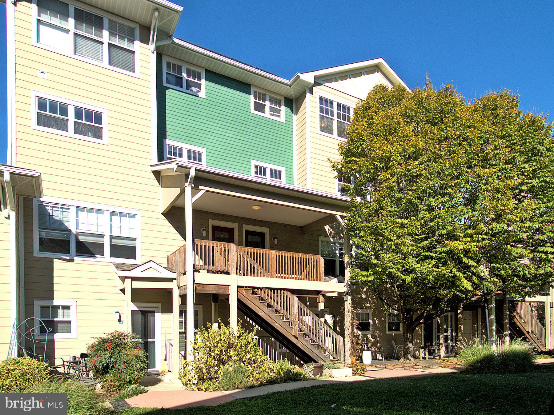 6827 4th Street Northwest, Unit 304 Washington, DC 20012 - Photo 2 of 23 a front view of a house with a yard