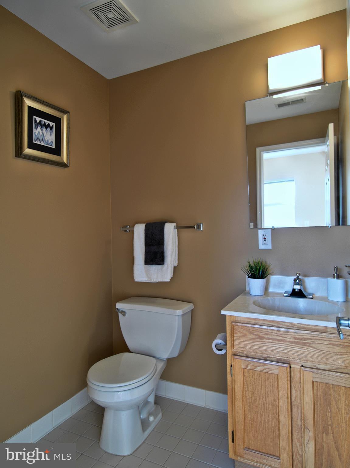 6827 4th Street Northwest, Unit 304 Washington, DC 20012 - Photo 11 of 23 a bathroom with a toilet a sink and mirror