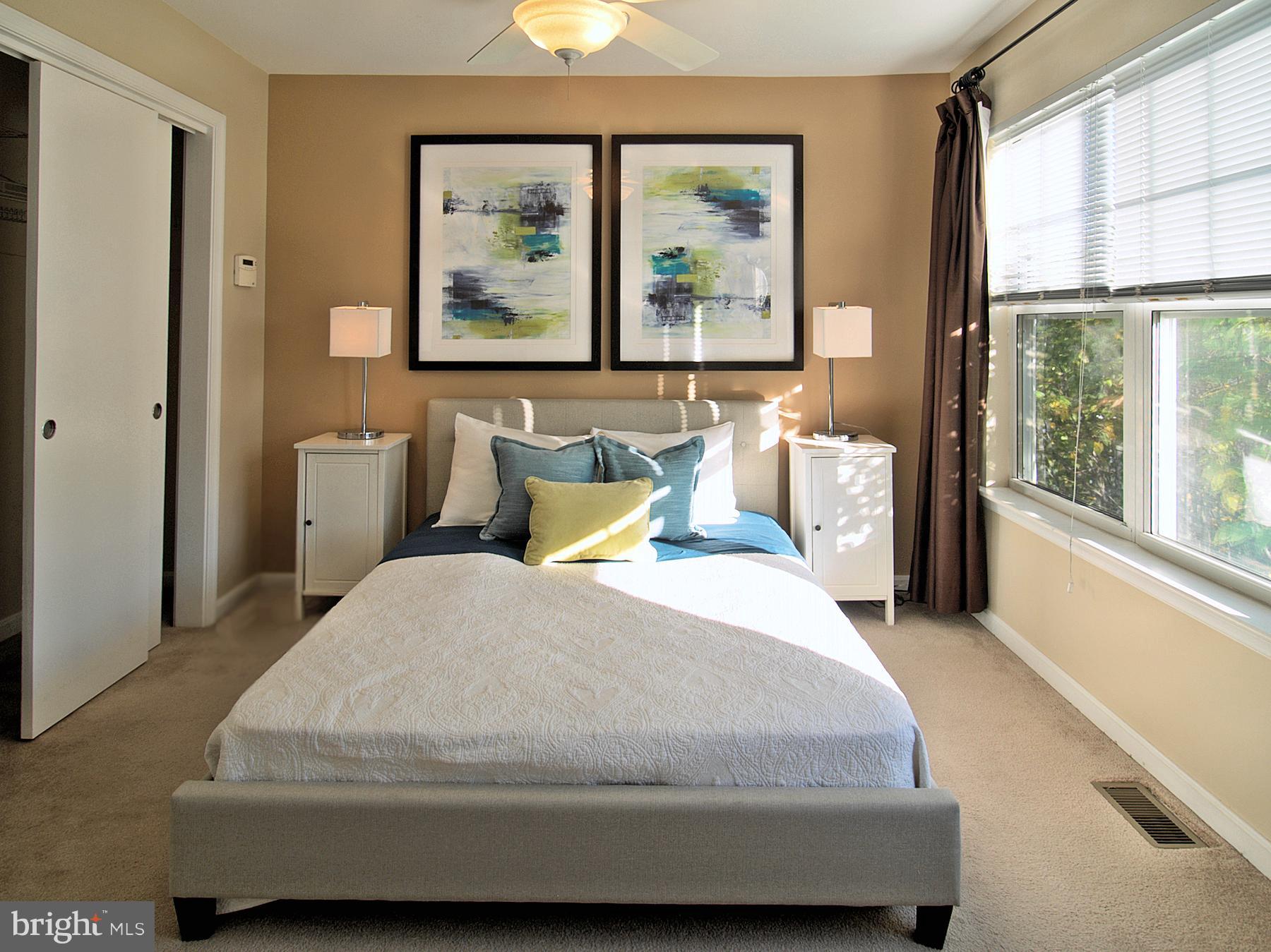 6827 4th Street Northwest, Unit 304 Washington, DC 20012 - Photo 13 of 23 a bedroom with a large bed and a large window