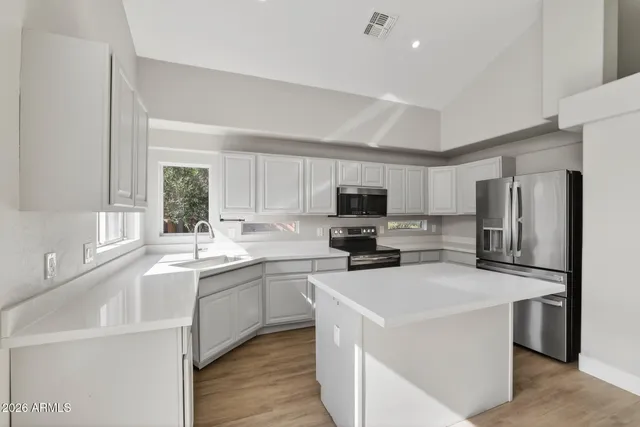 a kitchen with appliances a sink and a counter top space