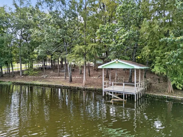 a view of a lake with a house swimming pool and outdoor space