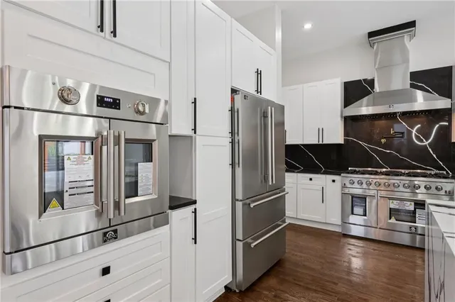 a kitchen with granite countertop a sink and cabinets