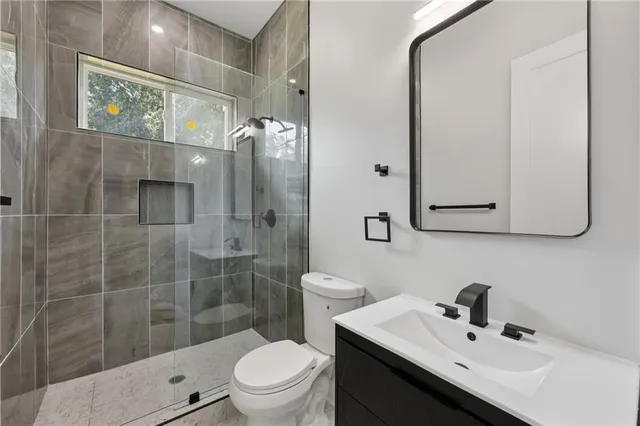 a view of a hallway with windows and wooden floor