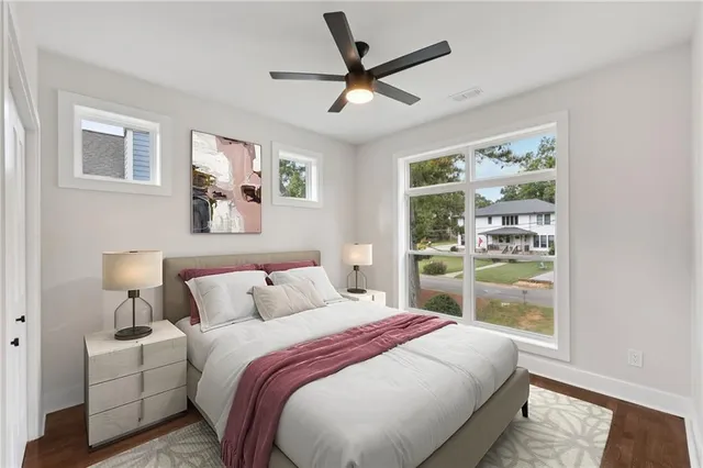 a view of wooden floor and a chandelier fan in a room