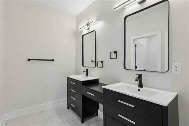 a bathroom with a double vanity sink a mirror and a bathtub