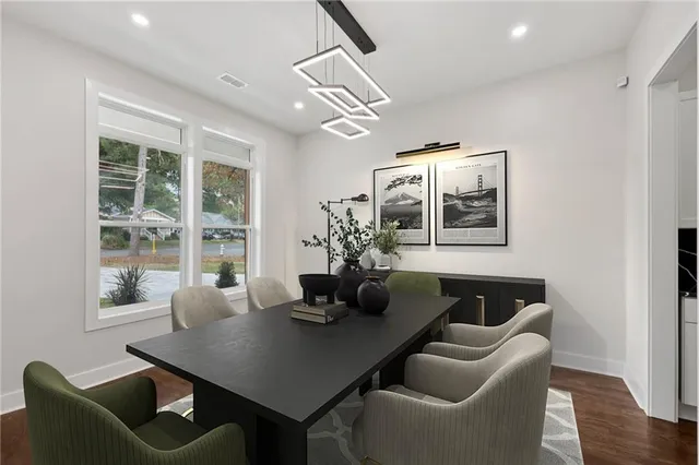 a dining room with furniture and wooden floor