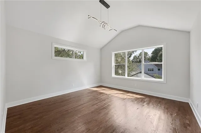 a view of a room with wooden floor