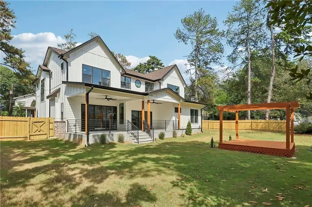 a view of a house with a yard and sitting area