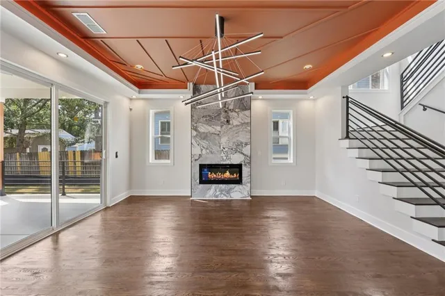 a view of a livingroom with wooden floor a fireplace and window