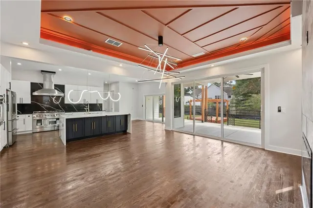 a living room with furniture and a dining table