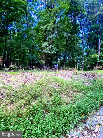 a backyard of a house with swimming pool and sitting area