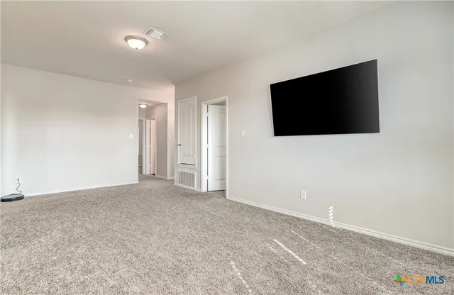 a view of an empty room with a flat screen tv