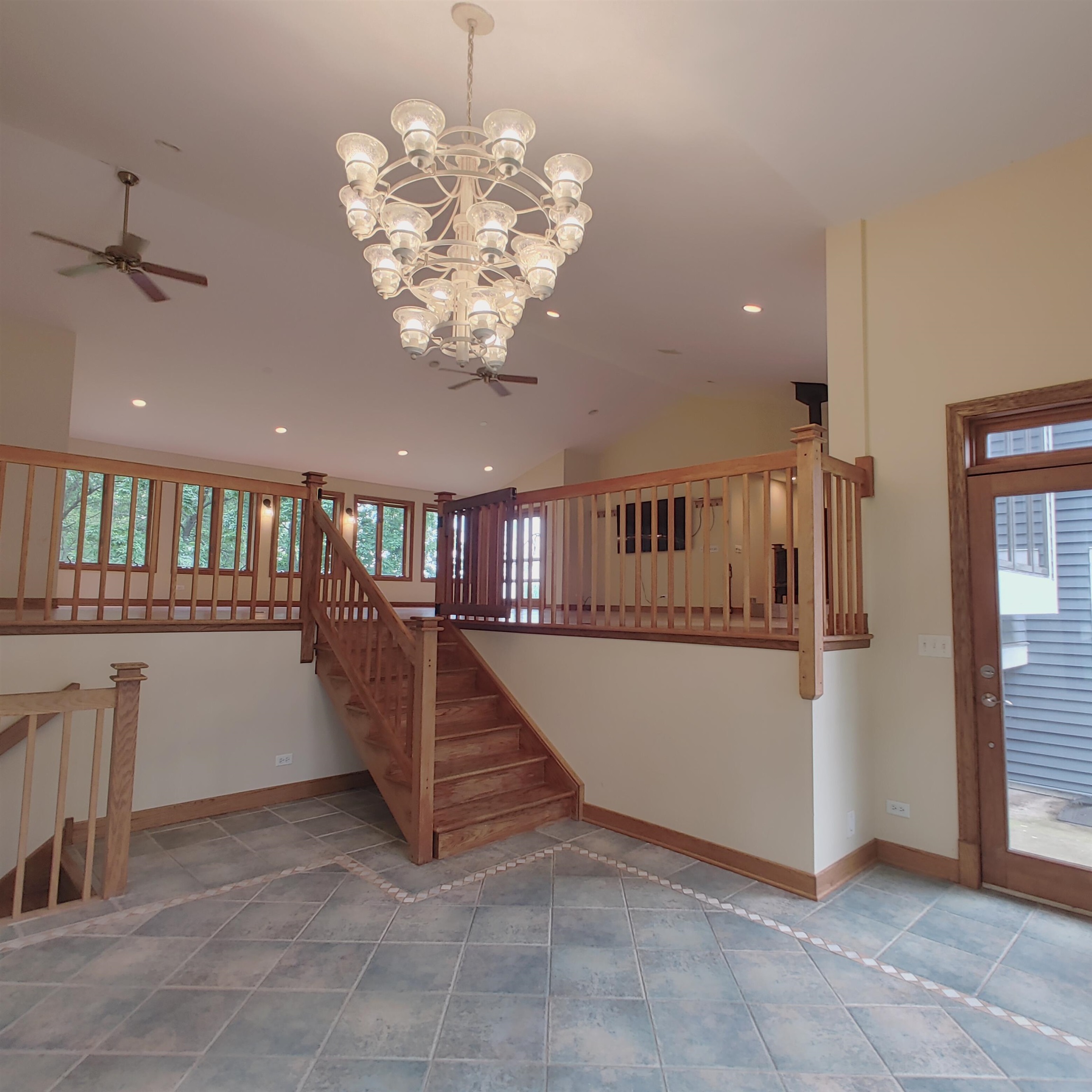 10799 Randall Road Capron, IL 61012 - Photo 20 of 68 a view of staircase and living room with a chandelier