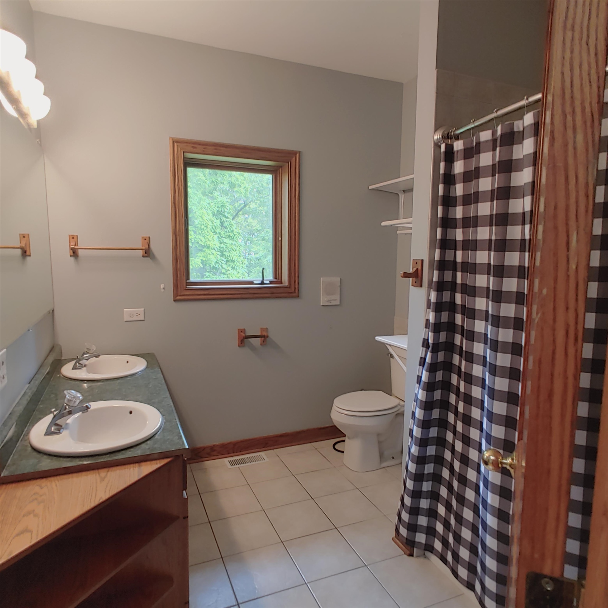 10799 Randall Road Capron, IL 61012 - Photo 50 of 68 a bathroom with a sink a toilet and shower curtain