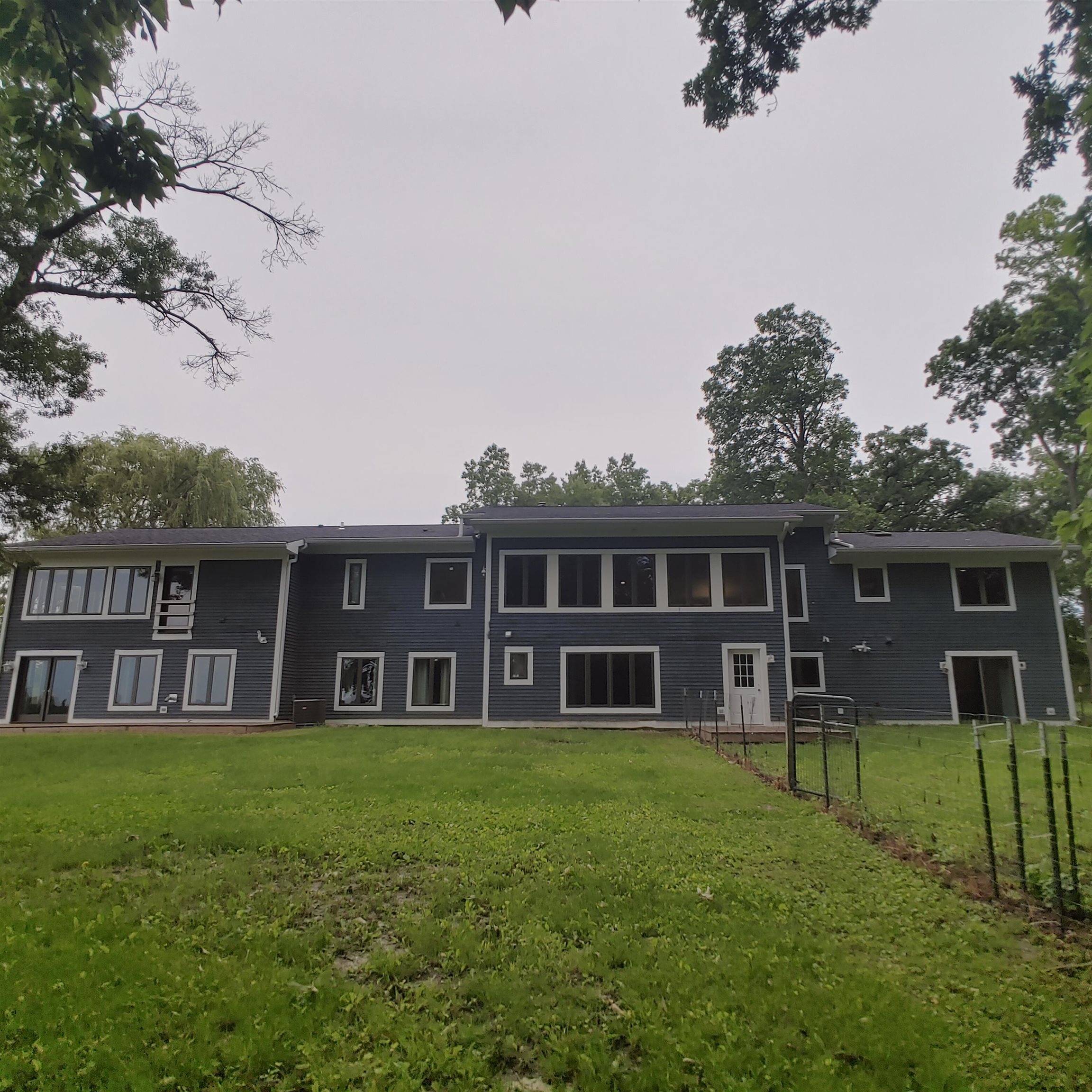 10799 Randall Road Capron, IL 61012 - Photo 7 of 68 a view of a house with a big yard and large trees