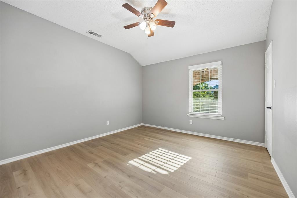 753 Summerfield Drive Allen, TX 75002 - Photo 26 of 40 Room featuring wood-finish flooring, a vaulted ceiling, and a ceiling fan with light fixture