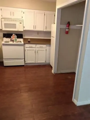 a kitchen with stainless steel appliances granite countertop a sink and a refrigerator