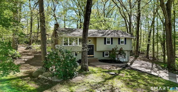 a backyard of a house with yard and outdoor seating