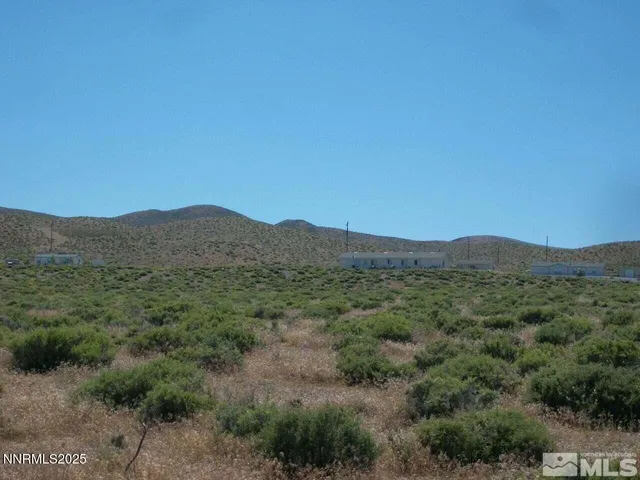 a view of a mountain range with trees in the background