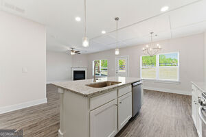 11164 Cornerstone Lane Hampton, GA 30228 - Photo 13 of 28 a kitchen with a sink chandelier and wooden floor