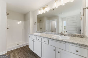 11164 Cornerstone Lane Hampton, GA 30228 - Photo 19 of 28 a bathroom with a granite countertop double vanity sink and mirror with shower