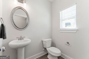 11164 Cornerstone Lane Hampton, GA 30228 - Photo 9 of 28 a bathroom with a toilet a sink and a mirror