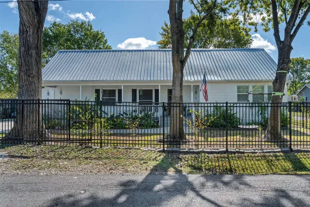 a view of a house with a yard and tree s
