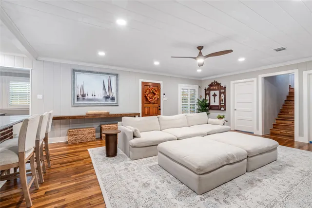 a kitchen with kitchen island a counter top space a sink stainless steel appliances and cabinets