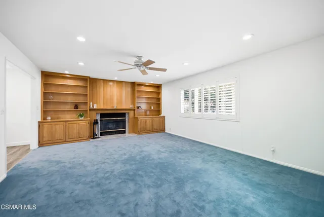 a view of a room with furniture and wooden floor