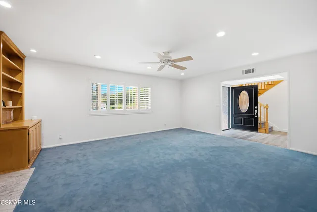 a kitchen with a sink a microwave a refrigerator and cabinets