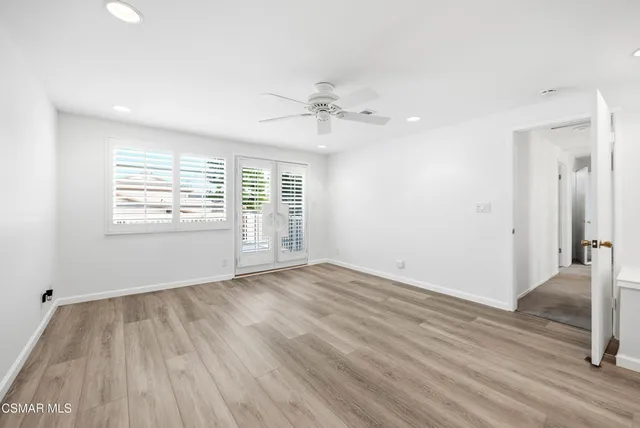 a view of a house with pool fire pit couches and wooden fence