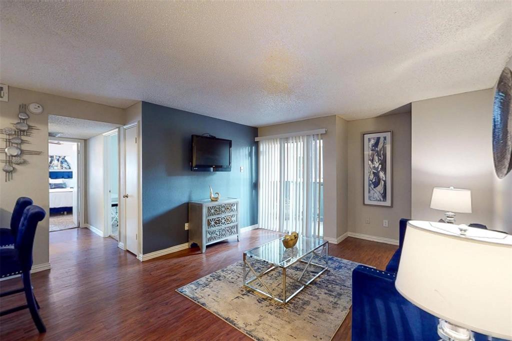 1826 Esters Road, Unit 1050 Irving, TX 75061 - Photo 5 of 39 Wood-finish flooring throughout, complemented by light-toned wall finishes and a contrasting accent wall
