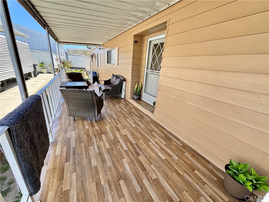 23301 Ridge Rte Drive, Unit 109 Laguna Hills, CA 92653 - Photo 13 of 46 a view of balcony with chairs and wooden floor