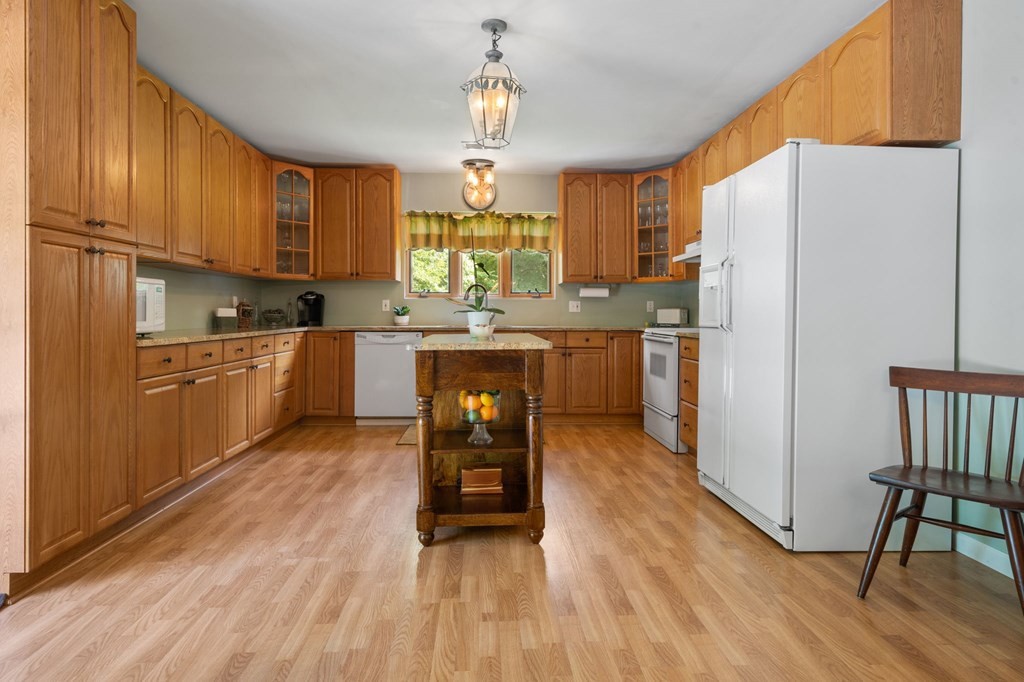 5597 South No Pone Valley Road Decatur, TN 37322 - Photo 14 of 44 a kitchen with stainless steel appliances granite countertop a refrigerator a sink dishwasher a dining table and chairs with wooden floor