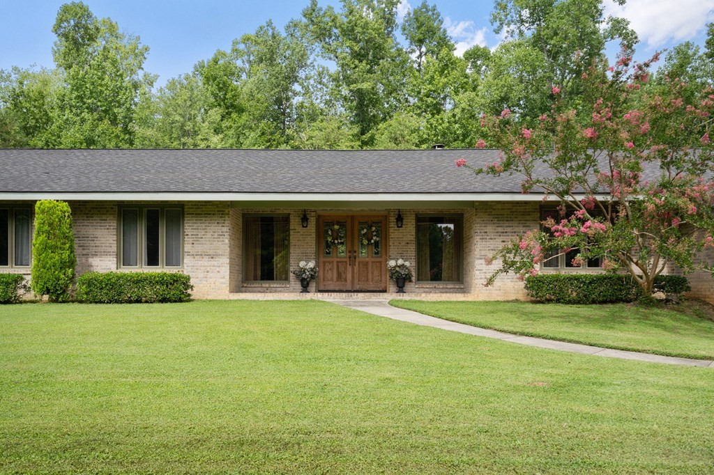 5597 South No Pone Valley Road Decatur, TN 37322 - Photo 2 of 44 a front view of a house with a garden and yard