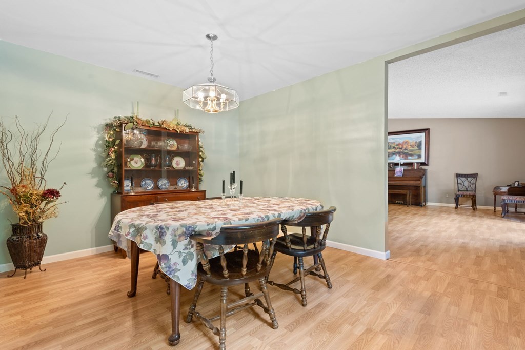 5597 South No Pone Valley Road Decatur, TN 37322 - Photo 21 of 44 a view of a dining room with furniture wooden floor and chandelier