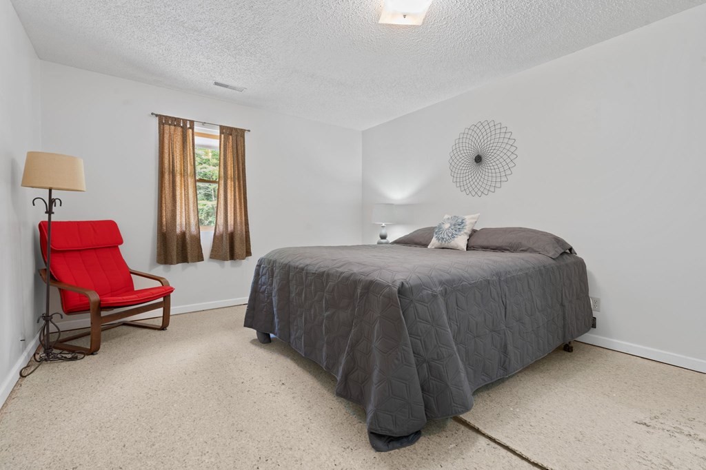 5597 South No Pone Valley Road Decatur, TN 37322 - Photo 27 of 44 a bedroom with a bed chair and window