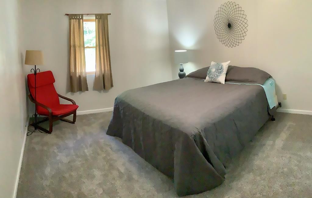 5597 South No Pone Valley Road Decatur, TN 37322 - Photo 28 of 44 a bedroom with a bed and chair