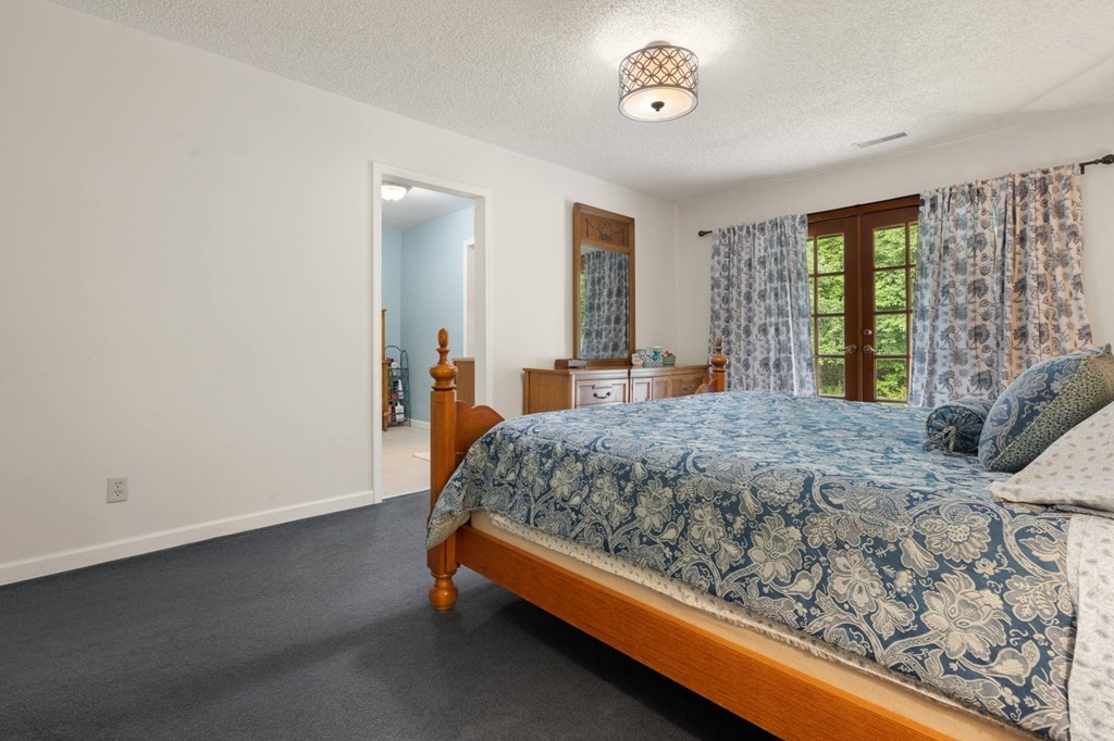 5597 South No Pone Valley Road Decatur, TN 37322 - Photo 30 of 44 a bed sitting in a spacious bedroom next to a window
