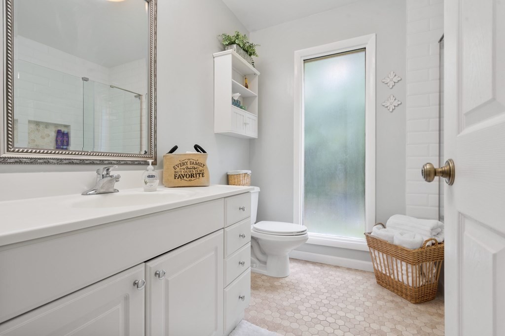 5597 South No Pone Valley Road Decatur, TN 37322 - Photo 35 of 44 a bathroom with a sink toilet a mirror and shower