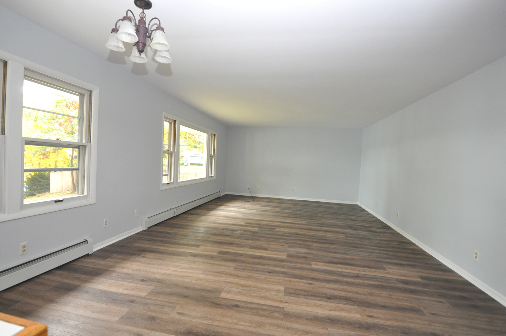 24111 64th Place Paddock Lake, WI 53168 - Photo 5 of 11 a view of an empty room with wooden floor and a window