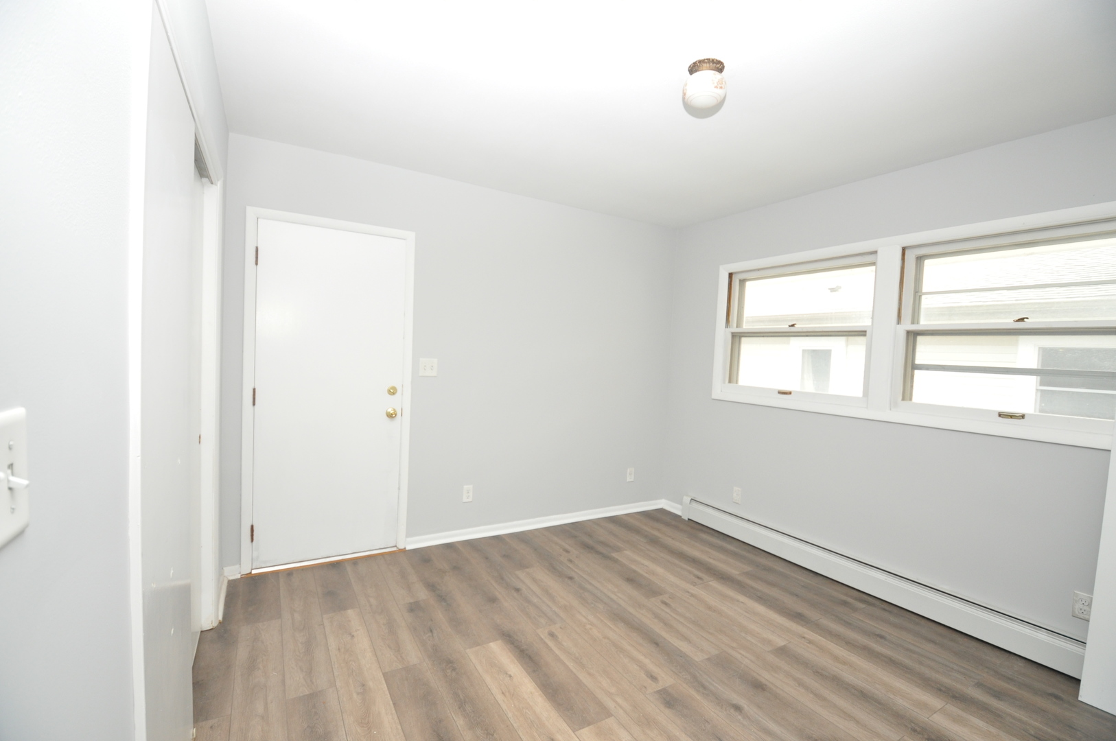 24111 64th Place Paddock Lake, WI 53168 - Photo 7 of 11 an empty room with wooden floor and windows