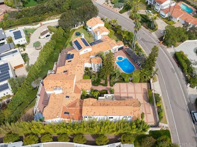 an aerial view of residential houses with outdoor space