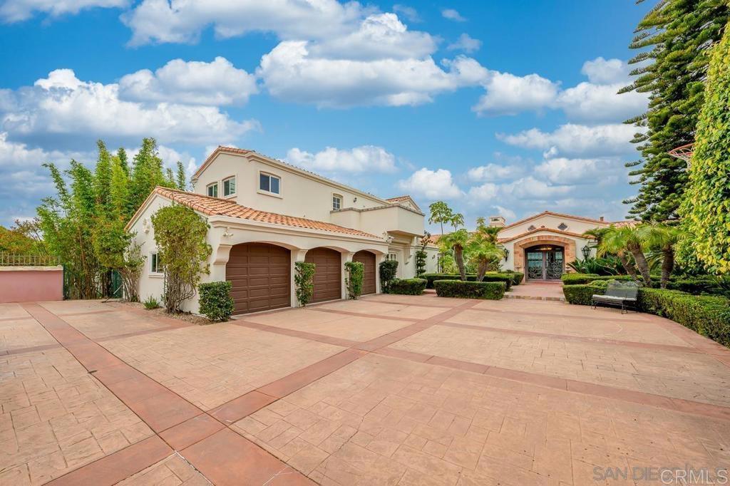 9450 La Jolla Farms Road La Jolla, CA 92037 - Photo 2 of 29 a front view of a house with a yard and trees