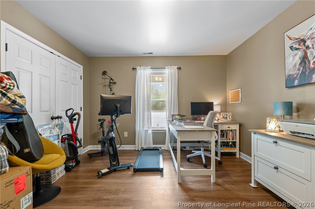186 Lewis Brown Road Bennett, NC 27208 - Photo 26 of 48 a view of a workspace with furniture and a livingroom