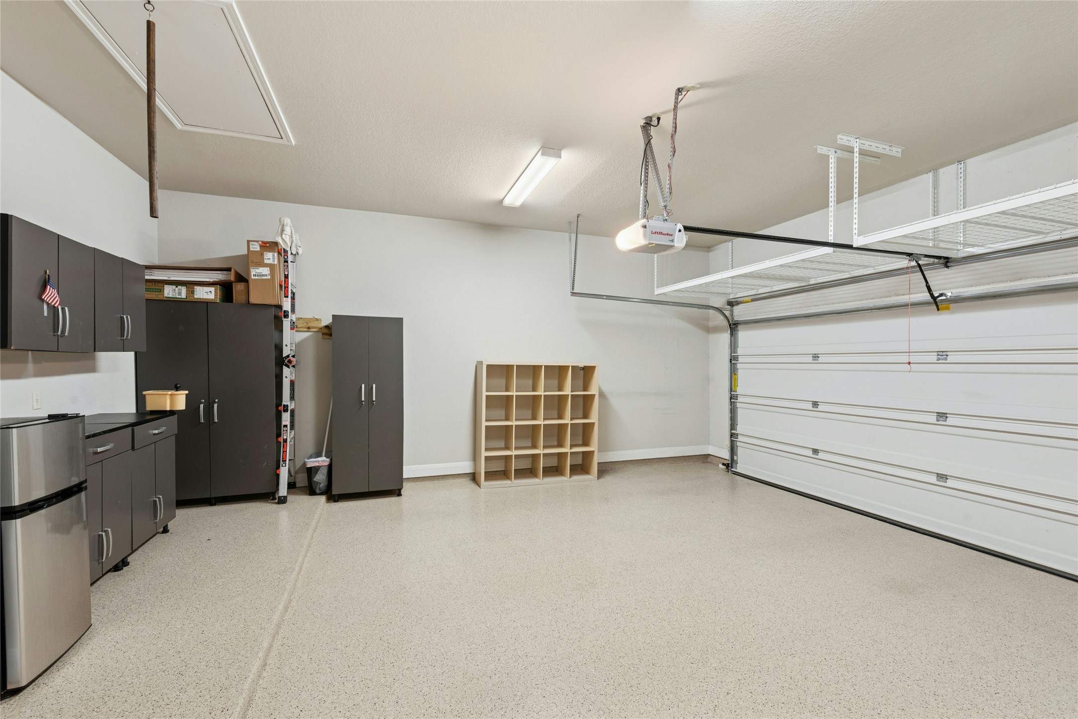 116 Evolutions Path Lakeway, TX 78738 - Photo 33 of 34 Garage with freestanding refrigerator and a garage door opener